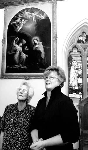 RESTORATION: Church warden Margaret Bramich and Jan Bramich admire the restored paintings at St Mary's Anglican Church, Hagley, yesterday. Picture: NEIL RICHARDSON