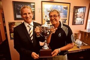 Hawthorn's Tasmanian operations manager Shayne Stevenson holds the Alec Campbell Cup with Tasmanian RSL vice-president Kent Luttrell. Hawthorn and North Melbourne will play for the cup on Sunday at Aurora Stadium. Picture: WILL SWAN