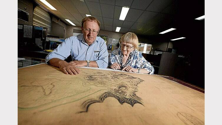 John Dent and Jenny Gill, of the Launceston Historical Society, with a early 1800s map of Launceston. Picture: GEOFF ROBSON