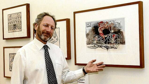 QVMAG director Richard Mulvaney with a cartoon in the Behind the Lines exhibition. Picture: NEIL RICHARDSON