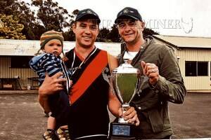 Bridgenorth captain Joel Clements, with his son Nate, 10 months, and coach Paul Beechey with the premiership cup yesterday. Picture: NEIL RICHARDSON.