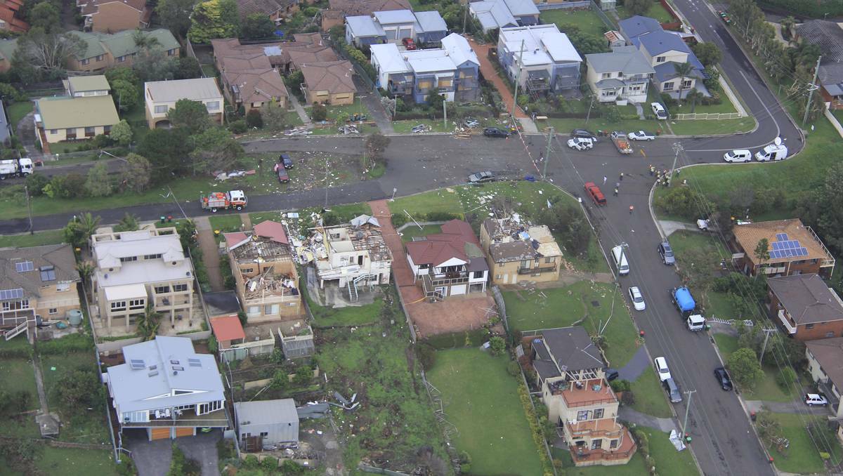 Experts survey the damage at Kiama, in the NSW Illawarra. Photos: COLIN DOUCH, DAVE TEASE