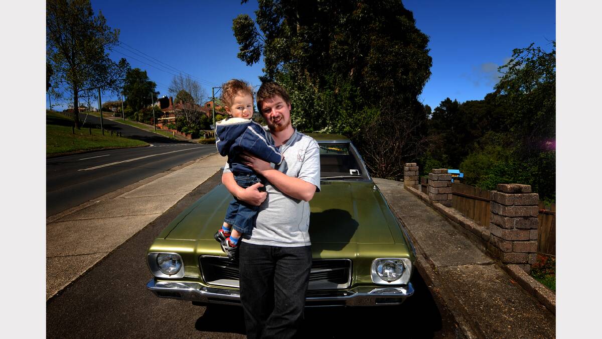 The nut: Ashley Turner, with nut-in-training Axel Turner. The car: 1972 Holden HQ Kingswood. Picture: Geoff Robson