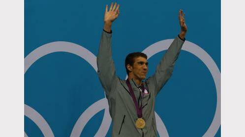  USA's Michael Phelps wins gold in the Men's 100m Butterfly finals at the Aquatic Centre.