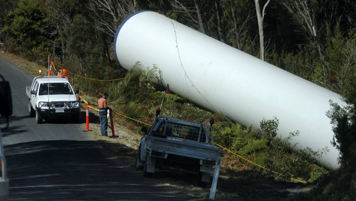 Contractors cordon off a section of a wind turbine tower that rolled off a truck near Gladstone early yesterday morning.