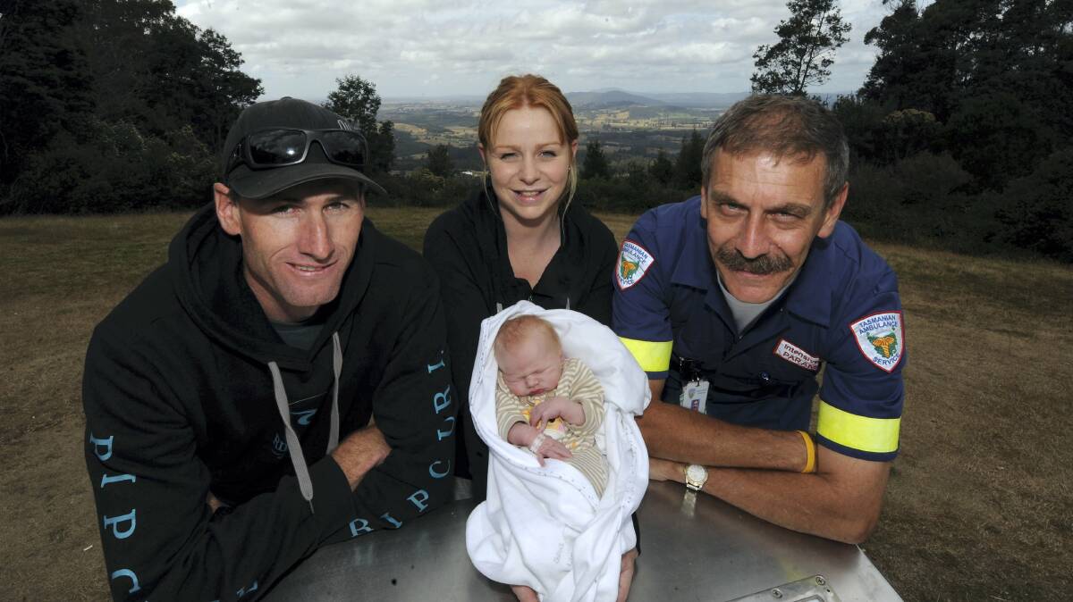 Jeffery Hayes and partner Natasha Hill, intensive care paramedic Peter James and newborn Kaiden Zane Hayes.  Picture: WILL SWAN