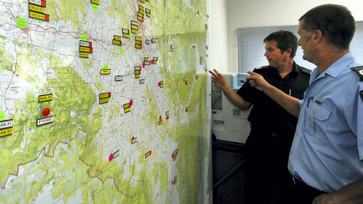 Tasmanian Fire Service district officers Stephen Lowe and Ian Bounds with fire plans.   Picture: GEOFF ROBSON