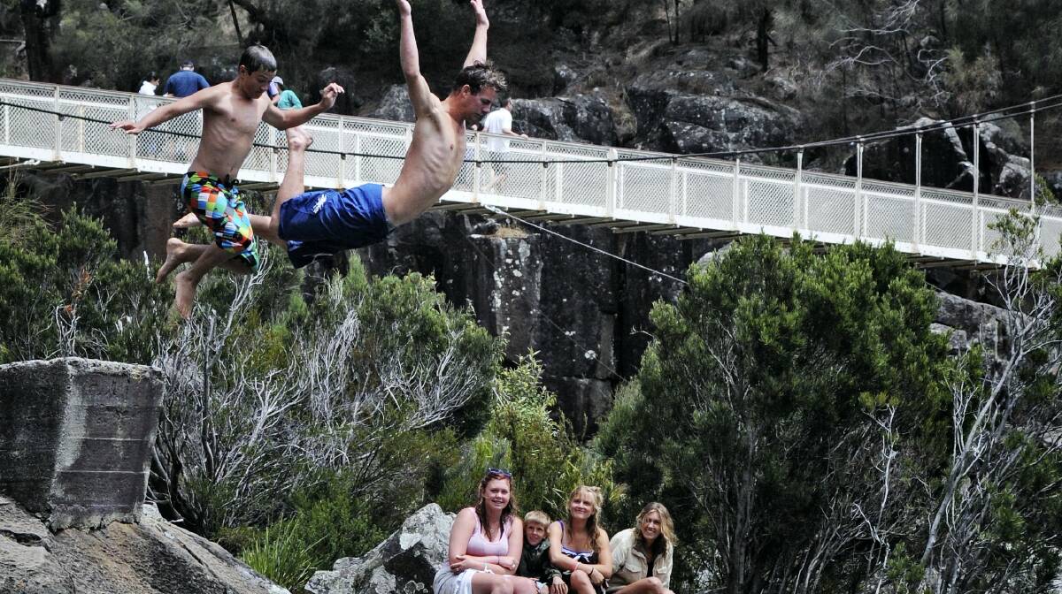 Having some fun in the sun at the First Basin are the Eilander cousins _ Beau, of Perth, WA, and Devin, of Launceston, taking the plunge, watched by Shannon, Zane, 5, Amber and Denni.