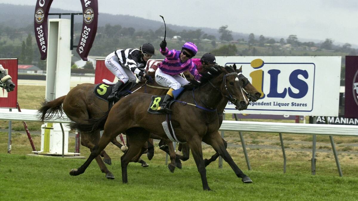 Jockey David Pires raises his whip in triumph after winning the Tasmanian Newmarket Handicap in 2003 aboard Dragila. Dragila's time since as a broodmare has been frustrating for her connections.