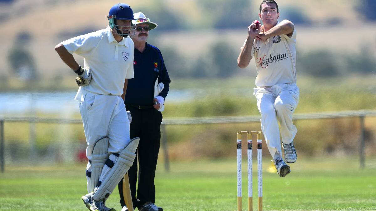 Riverside bowler Alex Saunders charges in to bowl yesterday against  George Town. 