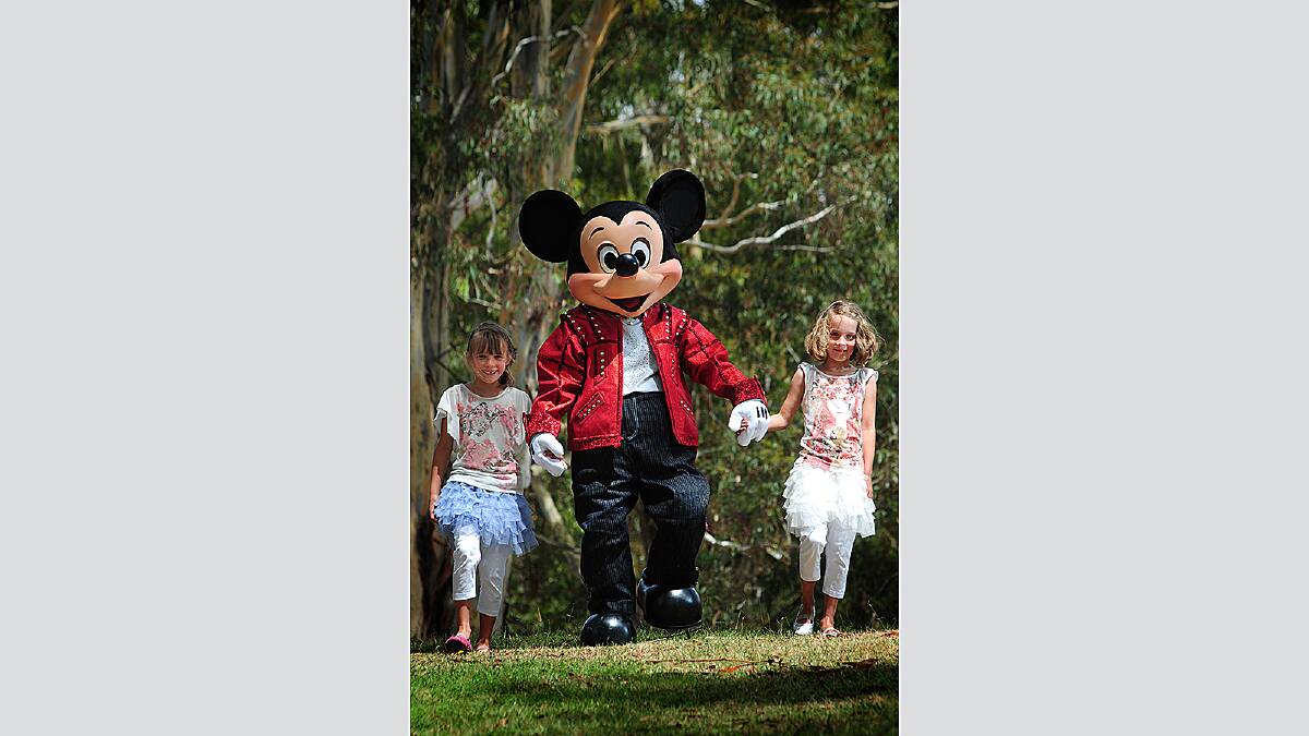 7 year old twins Amelie and Miette Richardson of South Launceston meet Mickey Mouse at the Silverdome Tuesday January 31 2012  photo:  Phillip Biggs  report:  Jayne Richardson