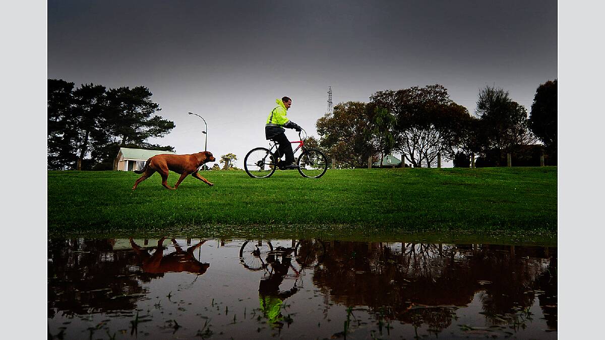 Richard Pearson of RIverside was out for a ride in the rain with Cleo, pictured at Tailrace Park. Friday September 21 2012  photo:  Phillip BIggs