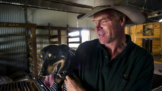 Craig Starr with his kelpie, Digger, at Gold Street Station in Hall, NSW. Photo: Rohan Thomson 