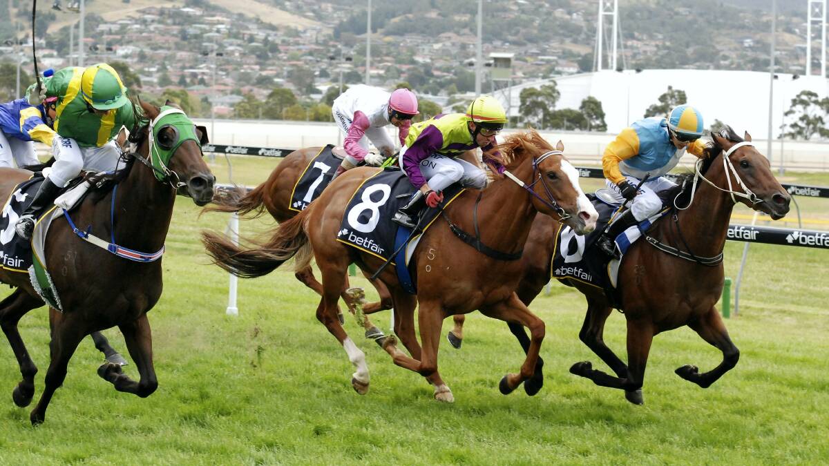 The Tasmanian summer racing carnival officially started in Hobart on Sunday when Moonless (inside), ridden by Georgie Catania, scored an upset win in the $100,000 Hobart Guineas. Picture: PETER STAPLES