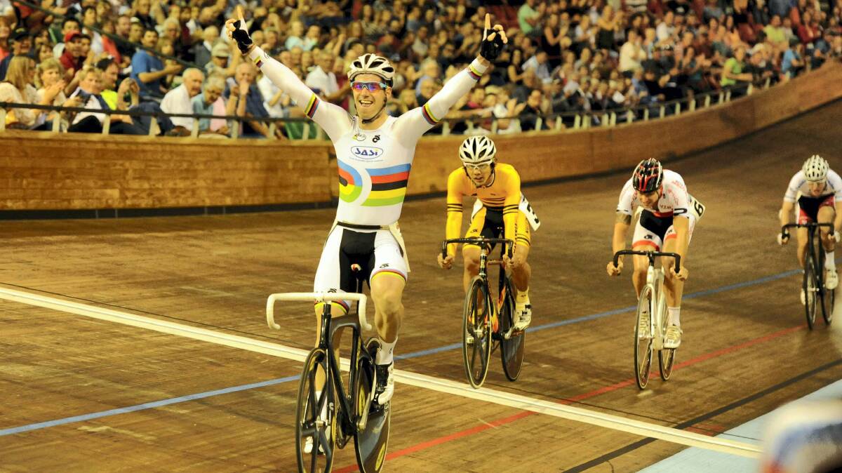 South Australian Olympian Glenn O'Shea raises his arms in triumph after crossing the line to win last night's Launceston Wheel at the Silverdome. Pictures: WILL SWAN