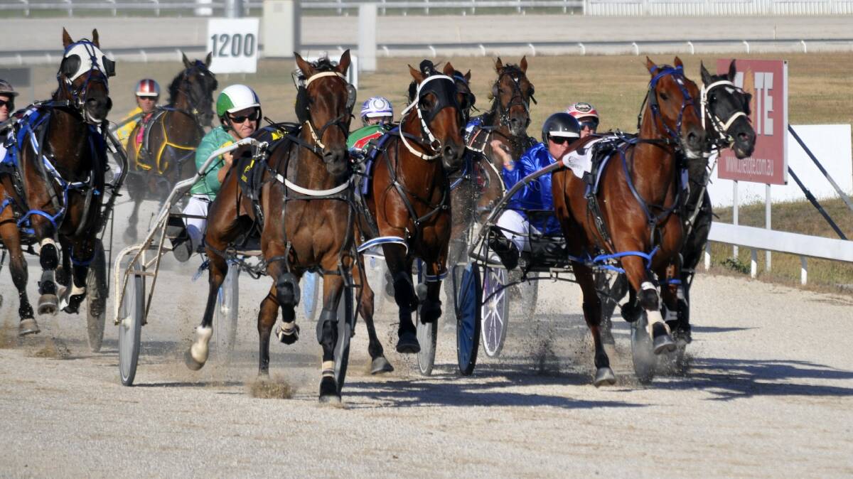 Former Victorian pacer Me Mate Les (green and white helmet), driven by James Johnson, charges down the outside to win the Chartley Estate Pace at Mowbray last night.