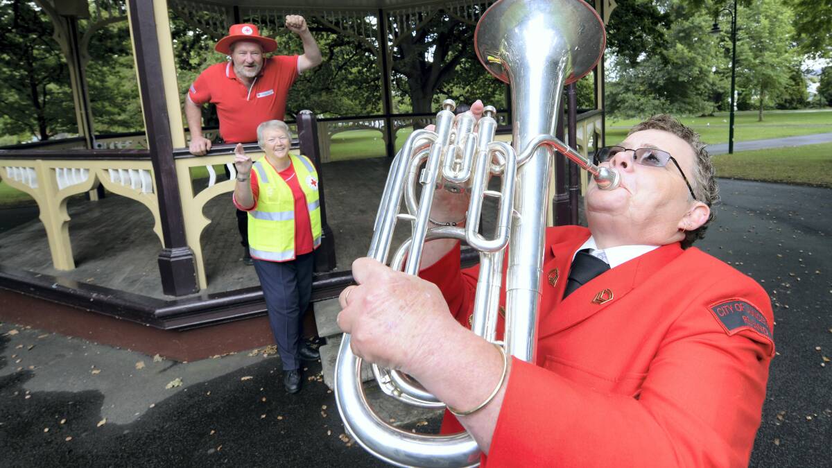 Kim Brundle-Lawrence, of Red Cross, warms up for the Red Cross Centenary Concert as Howard Colvin and Phyl Ockerby, of Red Cross, watch on. Picture: MARK JESSER