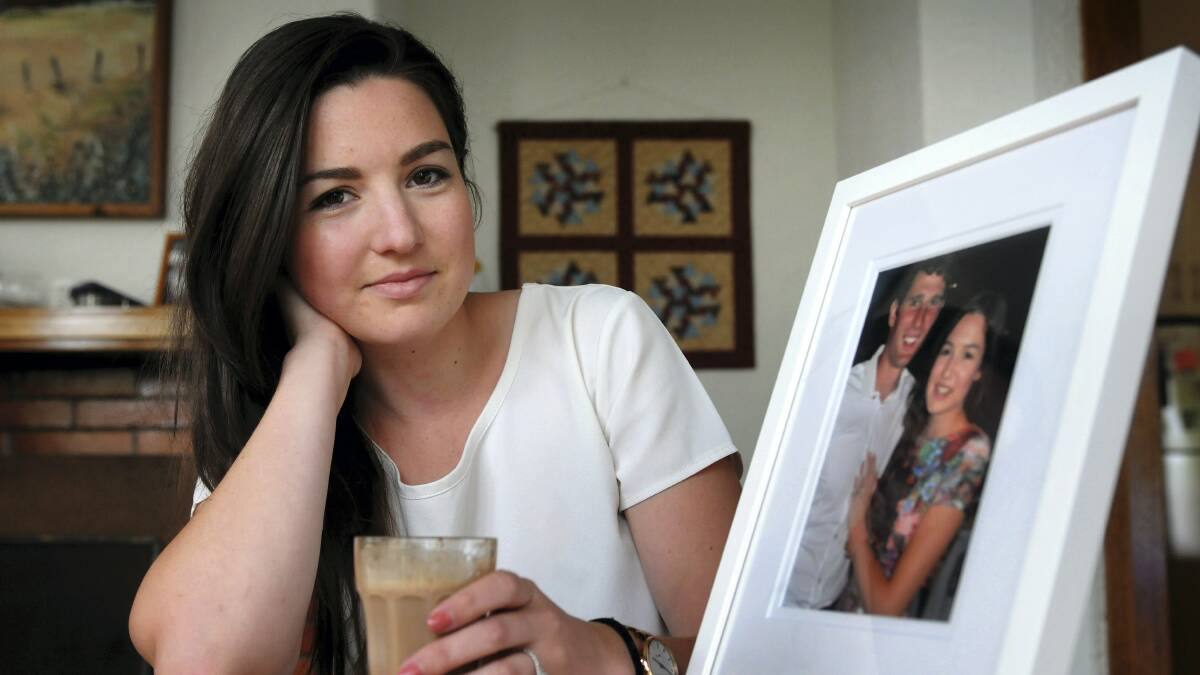 Erica Towns, 21, of Riverside, with a photograph of herself and her fiance, Jono O'Neill. The couple are part of a growing trend of marriage in young adults. Picture: PAUL SCAMBLER