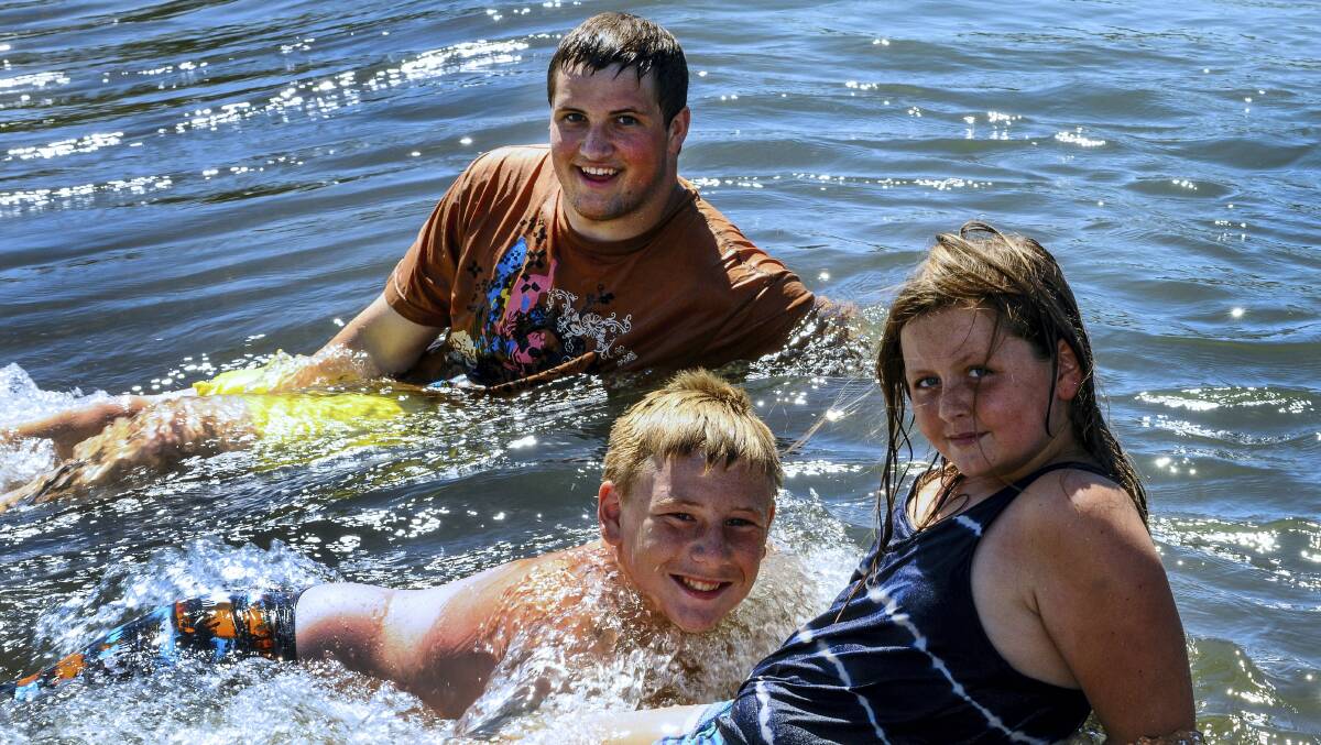 Jack Brindle, Chay Thomas and Kiarna Stonehouse, of Longford, cool off at the Mill Dam Reserve.   Picture: NEIL RICHARDSON