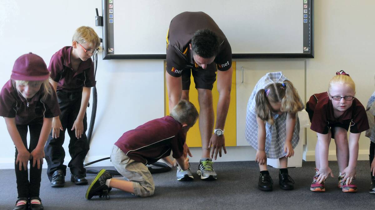 Hawks ruckman Ben McEvoy enjoys some yoga with  Ravenswood Primary School pupils. Picture: PAUL SCAMBLER