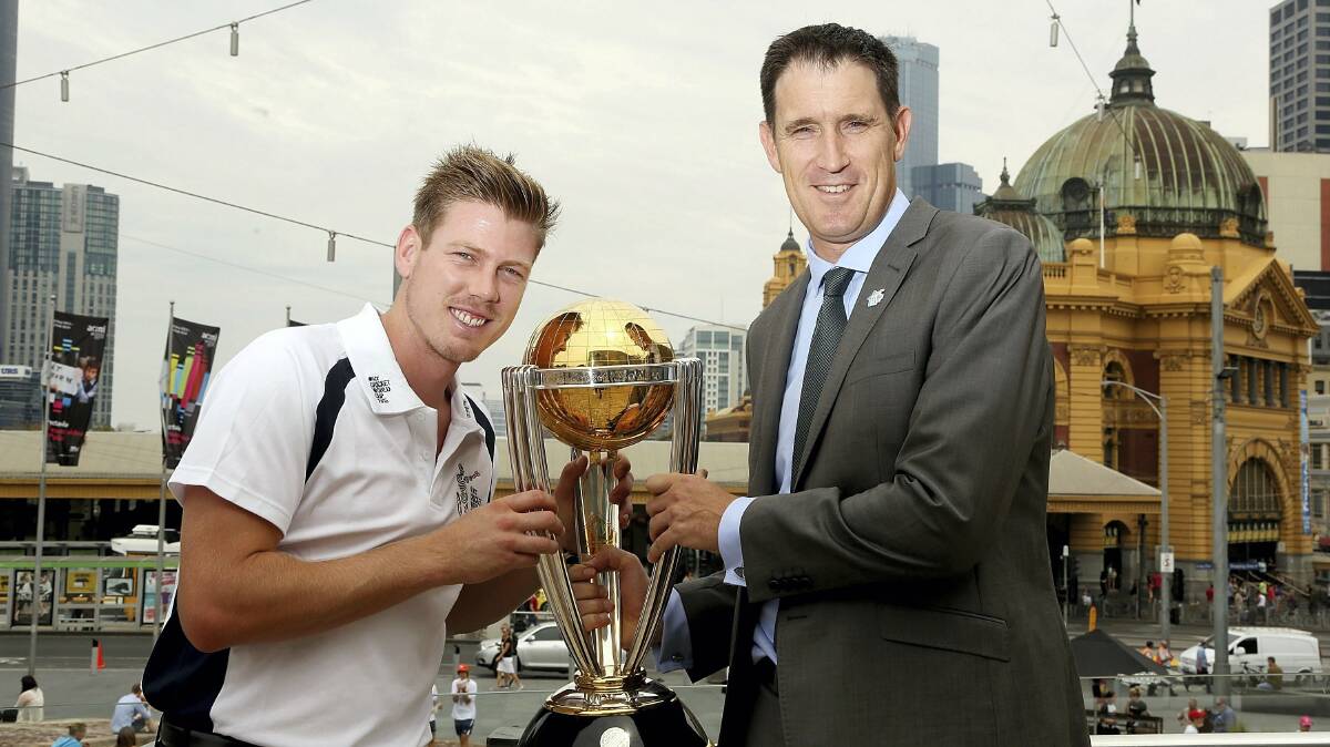 James Faulkner holds the one-day 2015 World Cup  trophy with  Cricket Australia chief executive James Sutherland in Melbourne yesterday. 