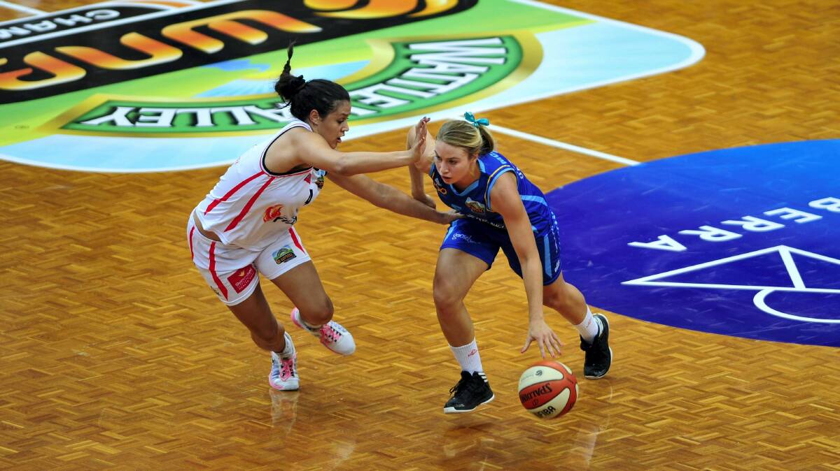 Townsville Fire player Alex Wilson  competes against Canberra Capitals' Sarah McAppion. The Tornadoes recruit has added WNBL rookie of the year to her accolades.  