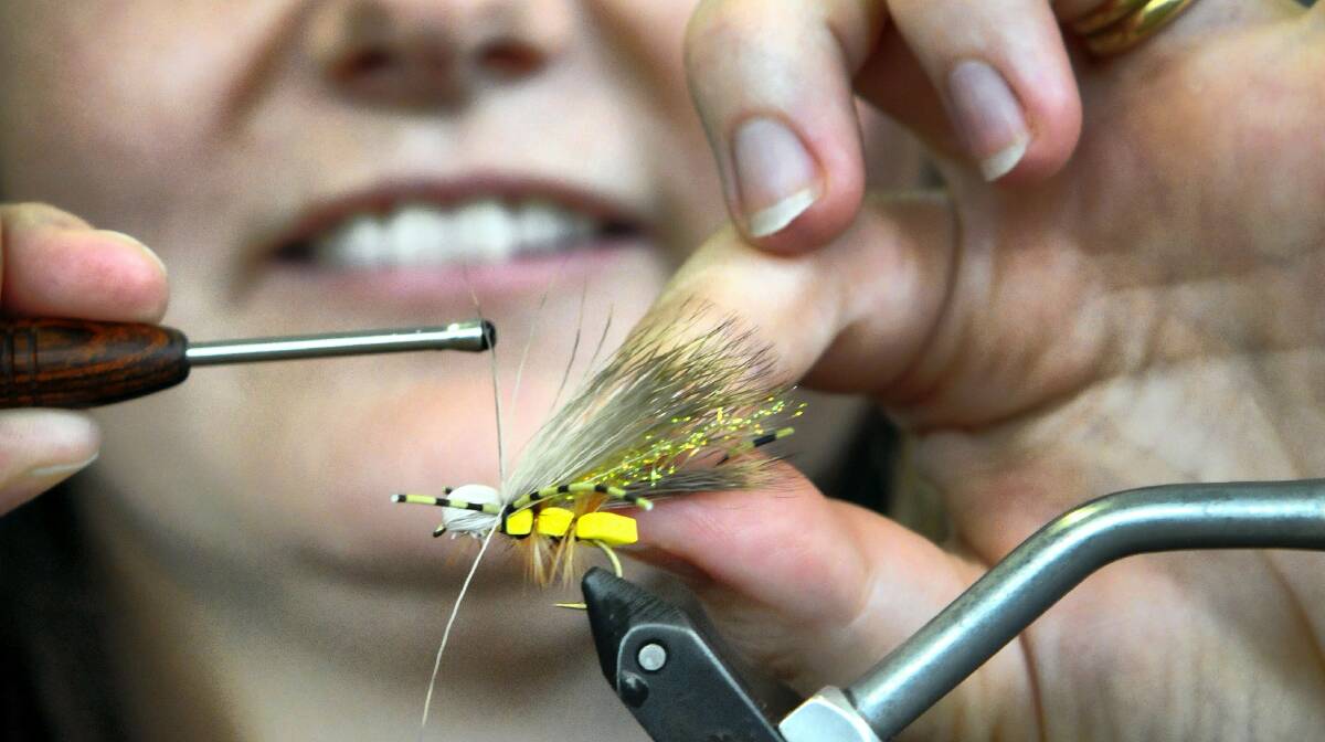 Simone Hackett, of Launceston, ties a WMD Hopper fly ahead of Sunday's Fly Fest at Relbia.  Picture: PAUL SCAMBLER
