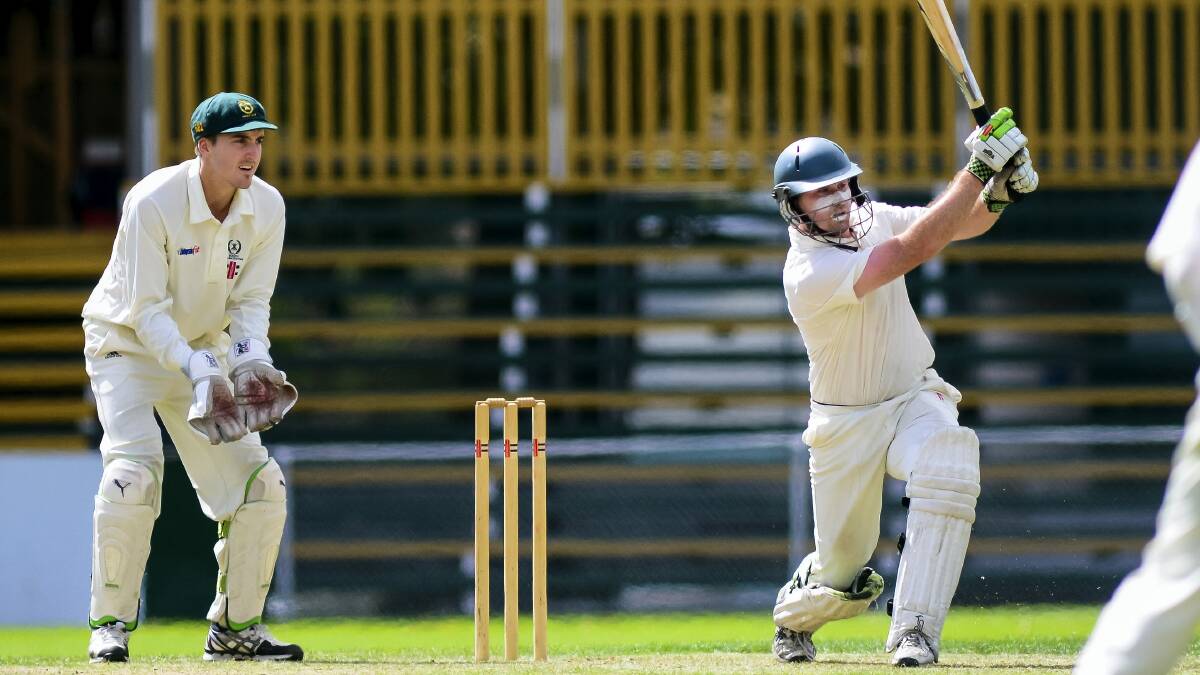  Launceston batsman Hayden Fenton smashes more runs yesterday as  South Launceston wicketkeeper Nathan Philip looks on. 