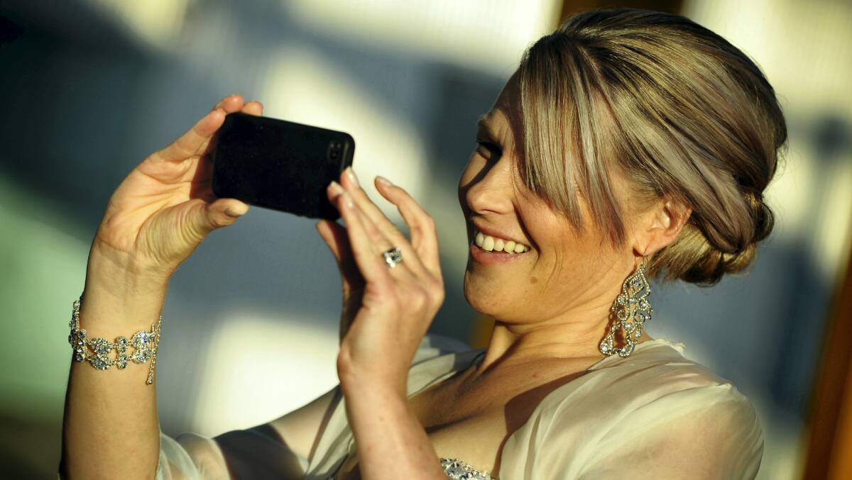 Newstead's Sarah Qualie snaps a photo for social media at the red carpet launch.  Pictures: SCOTT GELSTON  