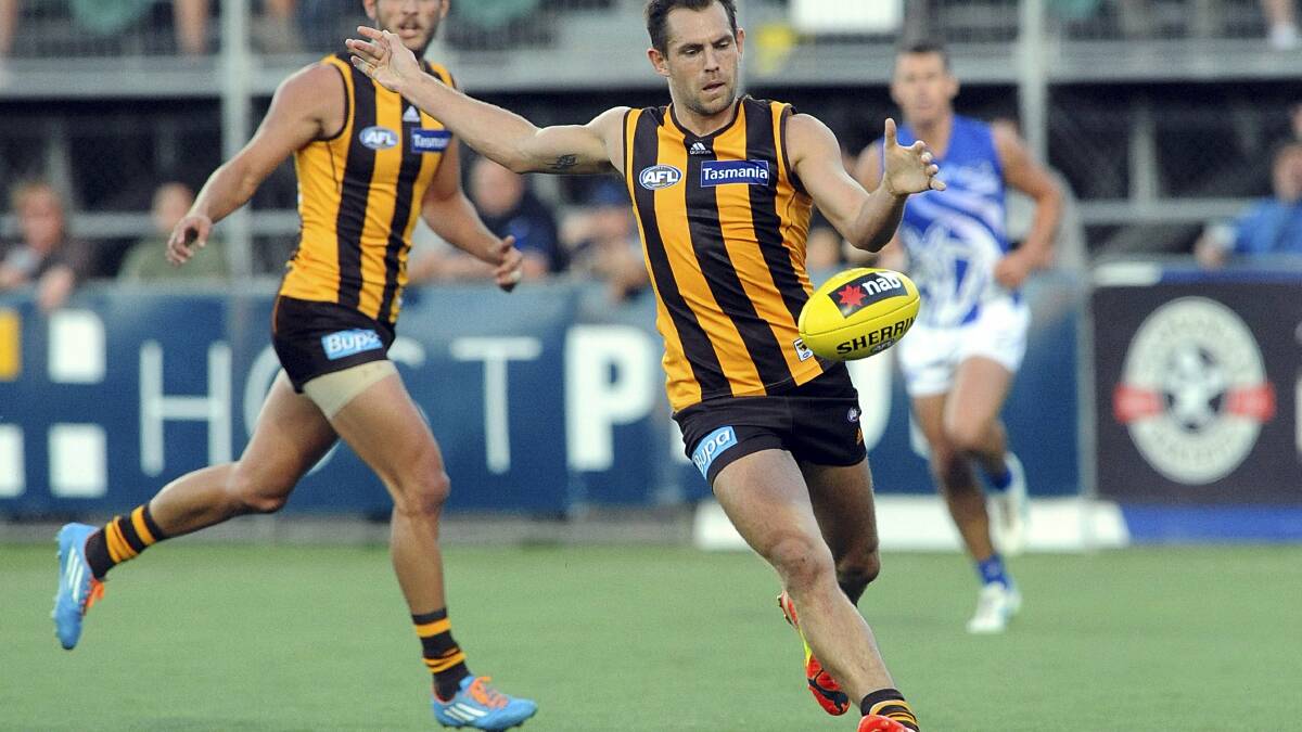 Hawthorn captain Luke Hodge gets clear and boots his side into attack into last night's NAB Challenge clash against North Melbourne at Aurora Stadium.  Picture: MARK JESSER.