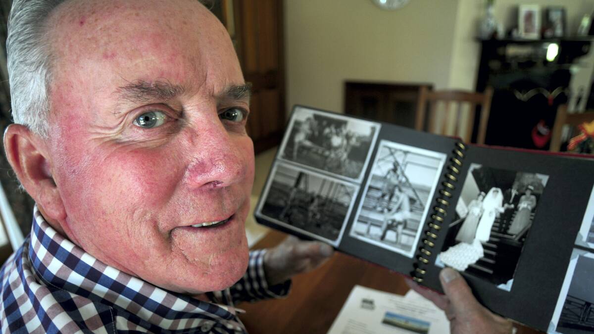 Kerry Finch, of West Launceston, looks through his photographs of Karratha, the West Australian mining town that was hit by tropical cyclone Christine.