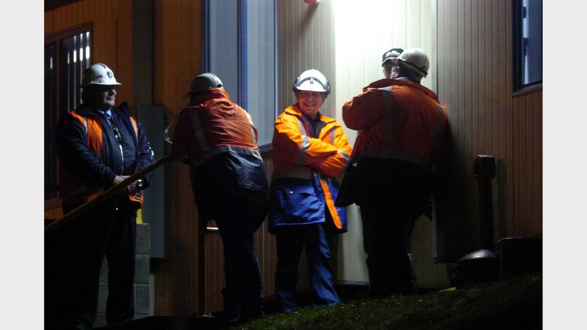 Five workers are all smiles in anticipation of Brant Webb and Todd Russell's appearance from the mine below