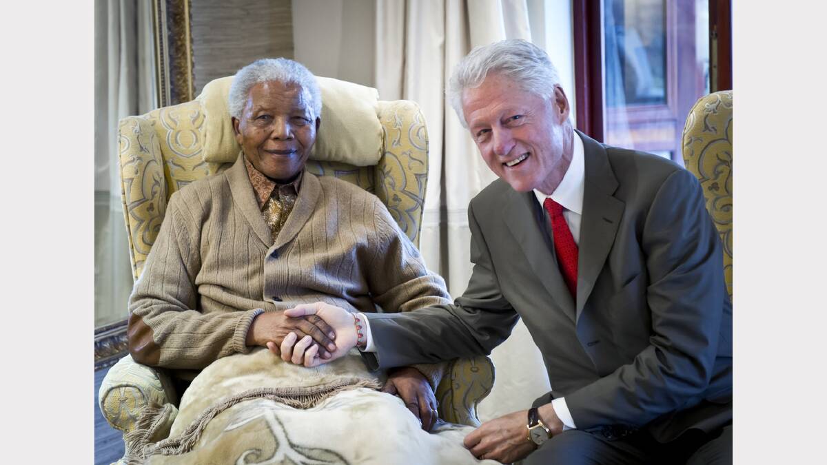 In this handout provided by the Clinton Foundation, former U.S. President Bill Clinton (R) poses with former South African President Nelson Mandela on the eve of his 94th birthday at his residence July 17, 2012 in Qunu, South Africa.