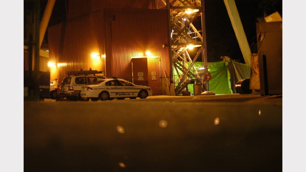Police cars wait outside the Beaconsfield Gold Mine following the mine accident.	