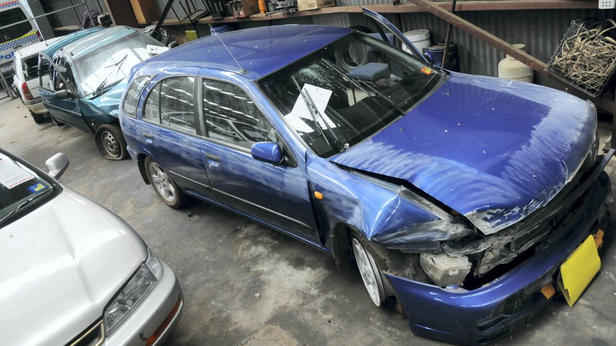 A 1998 Nissan Pulsar wagon is just one of a number of stolen cars in the police impound yard in Launceston. Picture: PAUL SCAMBLER