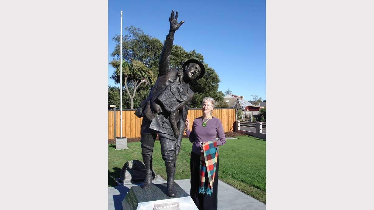 Ann Batalibasi, of Deloraine, with her great uncle Harry Murray's statue at Evandale.