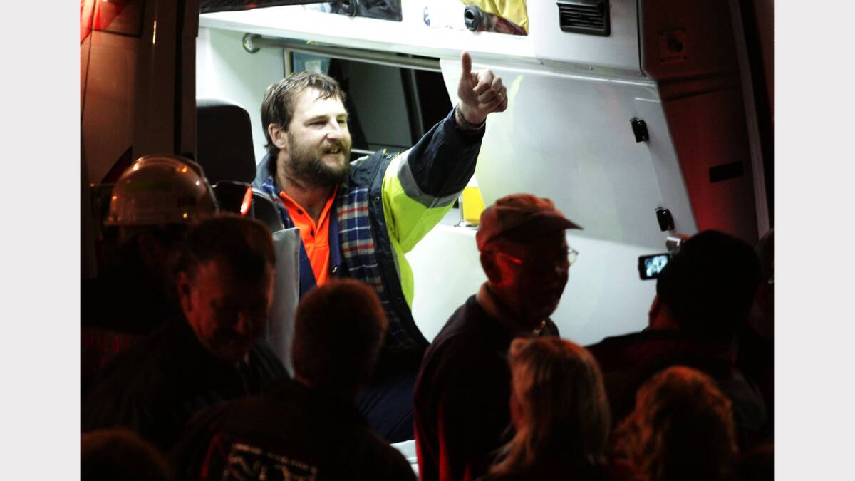 Todd Russell gives a thumbs up from the back of an ambulance after being rescued