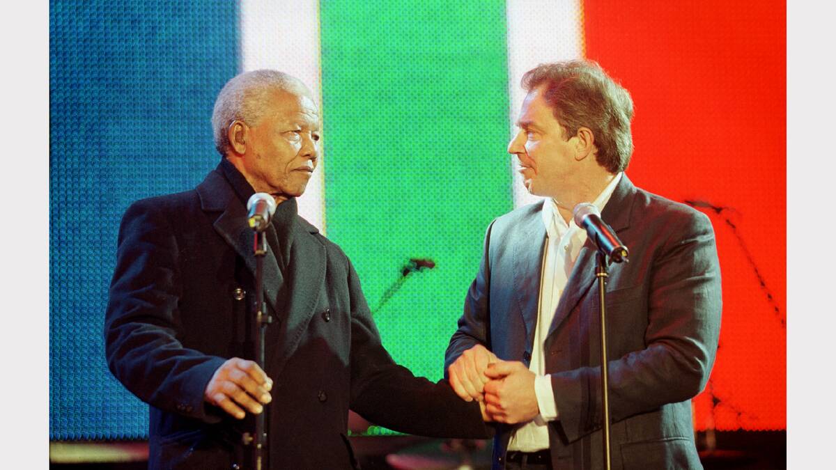 Ex-South African President Nelson Mandela, left, is greeted by the British Prime Minister Tony Blair at the Celebrate South Africa Concert April 29, 2001 in Trafalgar Square in London, England. The concert was held to celebrate 7 years of democracy in South Africa and to recognize the work of the UK founded Anti-Apartheid Movement. (Photo by Sion Touhig/Newsmakers)	