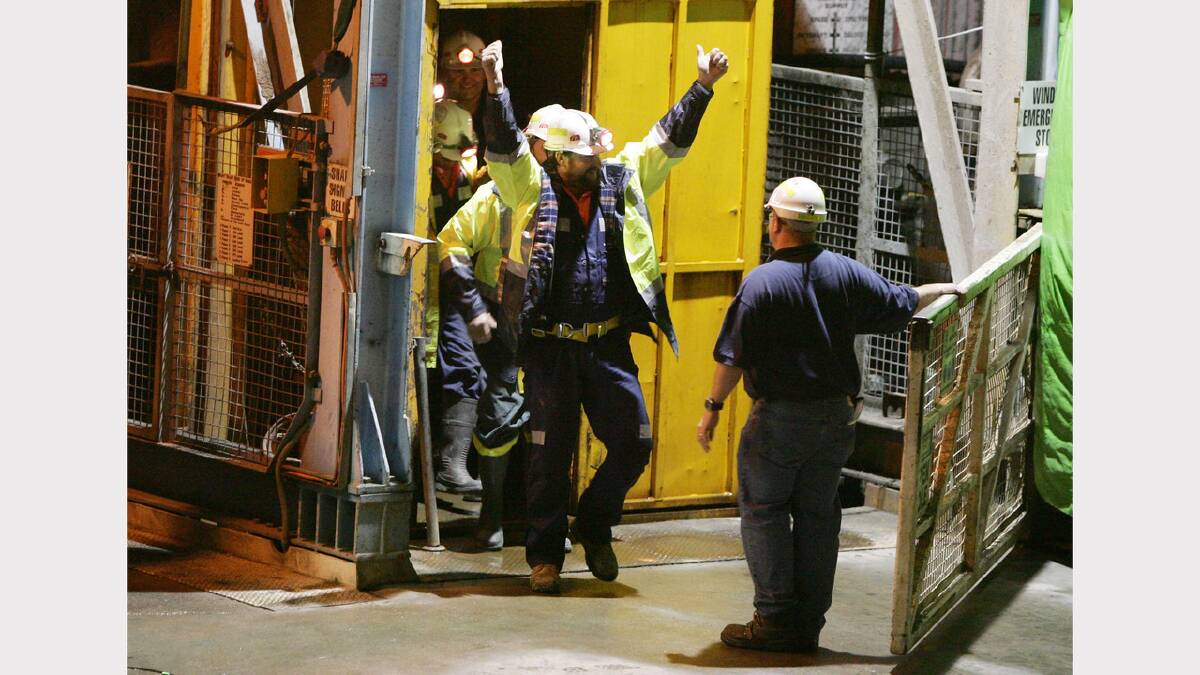 Todd Russell and Brant Webb punch the air as they emerge from the Beaconsfield Gold Mine after 13 days underground.