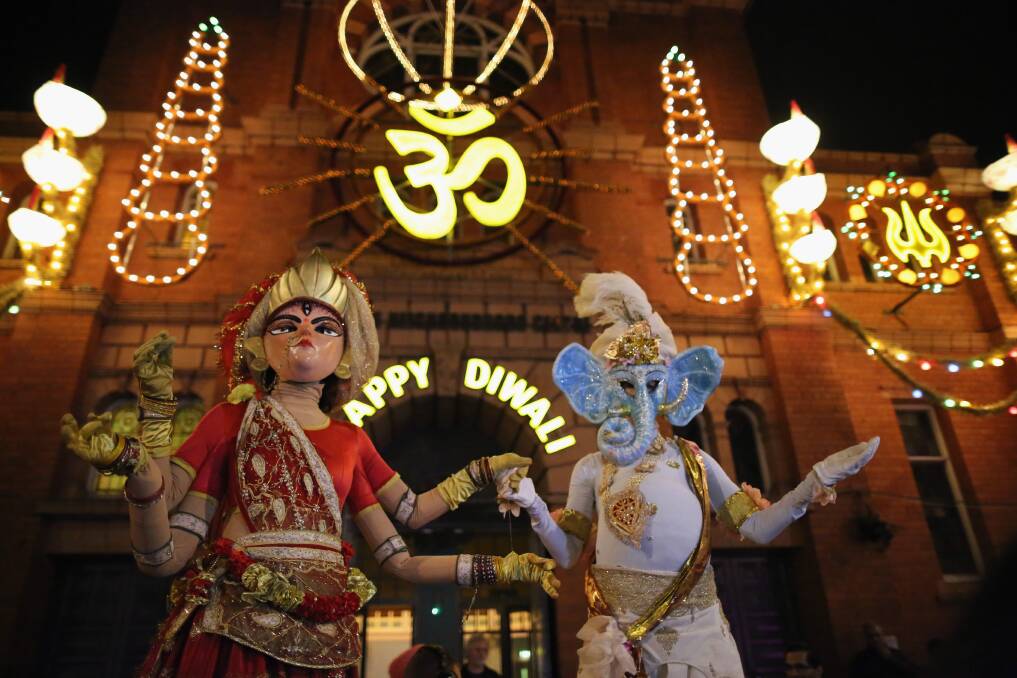 People dressed as the gods, Lord Ganesha and Goddess Lakshmi, walk through the streets during the Hindu festival of Diwali on November 13, 2012 in Leicester, United Kingdom. Photo by Christopher Furlong/Getty Images