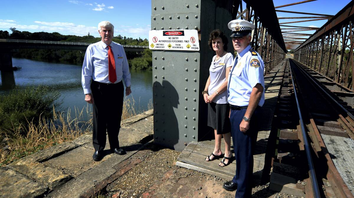 Northern Midlands acting general manager Lindsay Harwood, Maree Brickell and Senior Sergeant Chris Parr at the bridge. Picture: GEOFF ROBSON