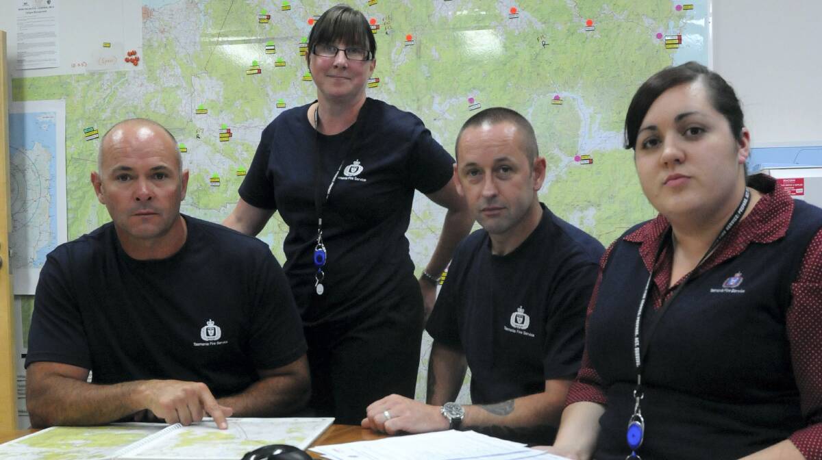 TFS air attack supervisor Paul Beechey, public information officer Lynda Robins, regional fire controller Steve Richardson and management support Lisa Gilbert at the  Youngtown headquarters. Picture: PAUL SCAMBLER