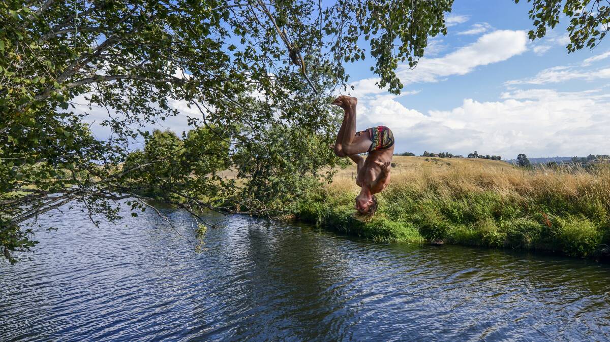 Sam Wood, of West Launceston, backflips into the North Esk River at St Leonards. Picture: PHILLIP BIGGS
