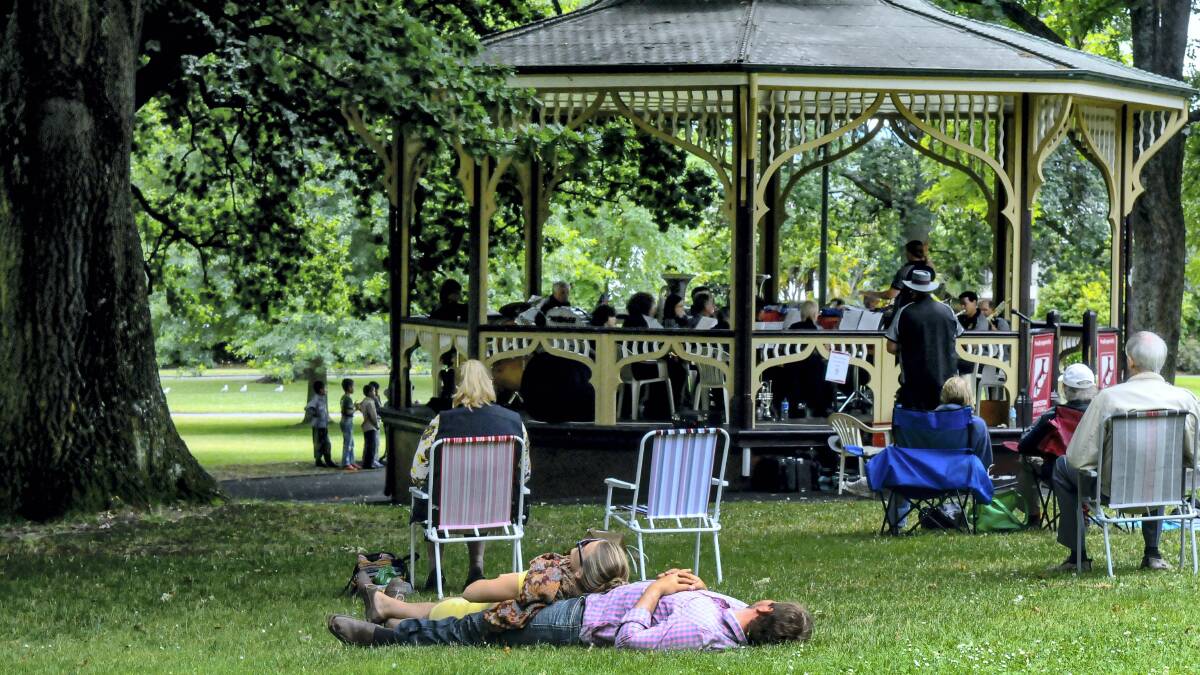 Dallas and Rosie Kotrba, of Launceston, lie on the grass listening to the Launceston Railway Silver Band in  the City Park. Pictures: NEIL RICHARDSON