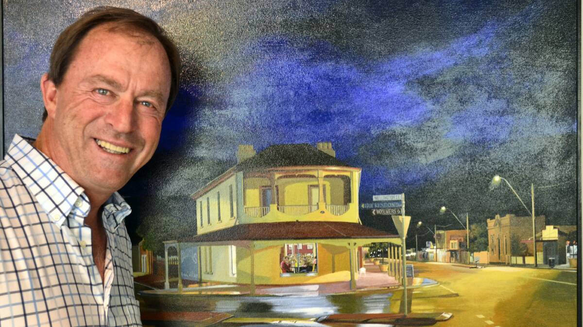 Media personality Neil Kearney with his prized painting of Roy Preece's old Longford store by Longford artist David Lake.