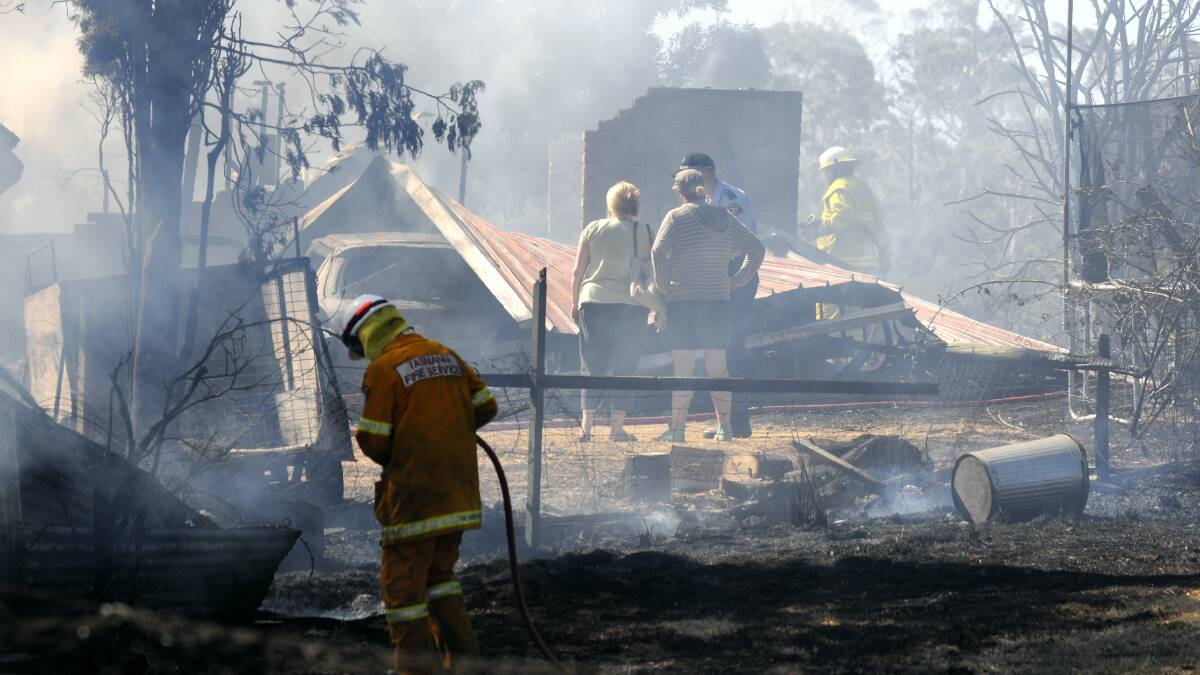 The property owners arrive to find their home at Rowella  gutted by fire yesterday.