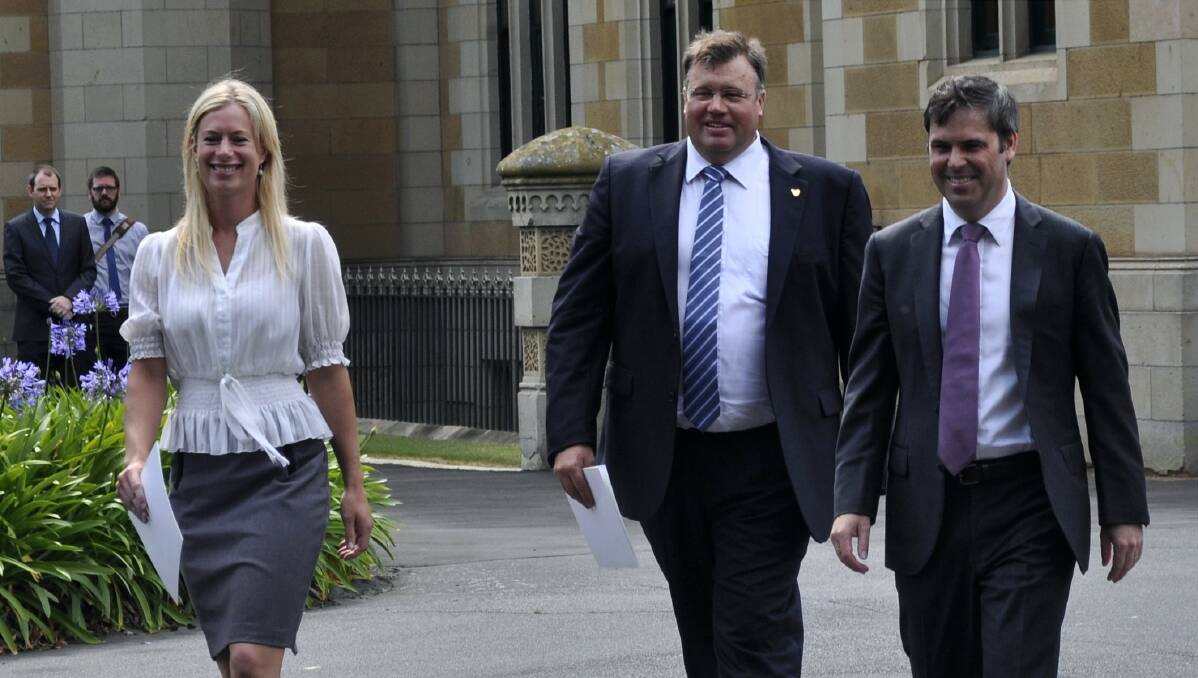 The two new Labor ministers, Rebecca White and Craig Farrell, leave Government House with Attorney-General Brian Wightman, who has also taken on the Education and Skills portfolio. Picture: GEORGIE BURGESS