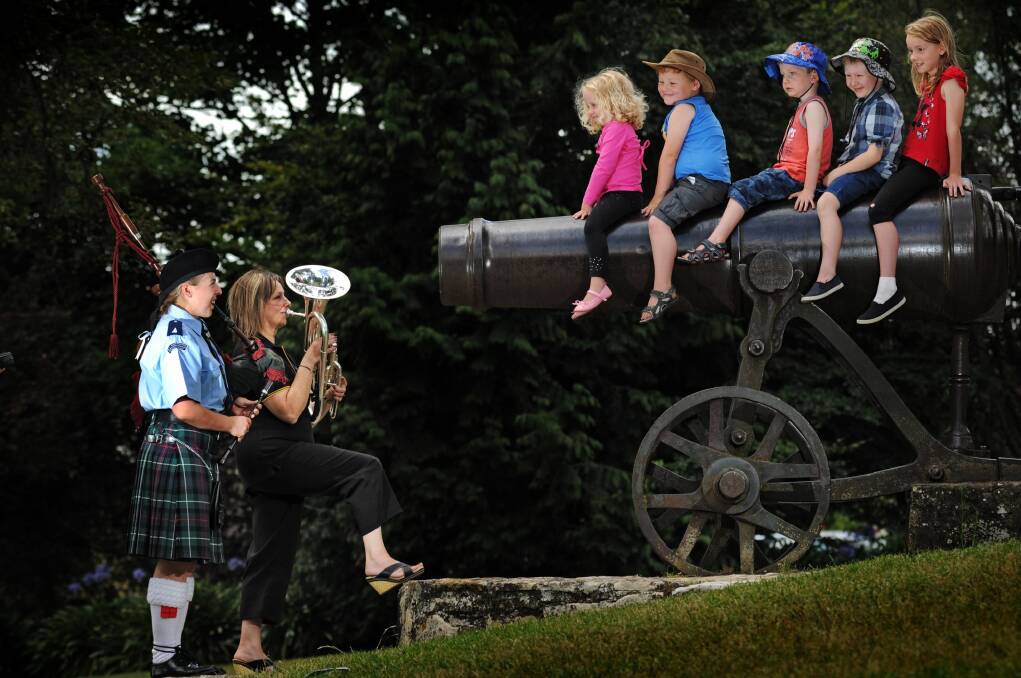 The St Andrew's Caledonian Pipe Band's Sally-Anne Richter and the West Tamar Municipal Band's Kerry Ellis play for Amy Barber, 3, Fletcher Langdon, 5, Jackson Murfet, 5, Brodie Barber, 6, and Ashley Murfet, 8.