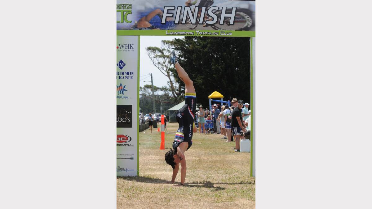 Melissa Clark, of Bridgenorth, celebrates her win in the women's section of the Tasmanian triathlon series first race for 2013 at Beauty Point yesterday.